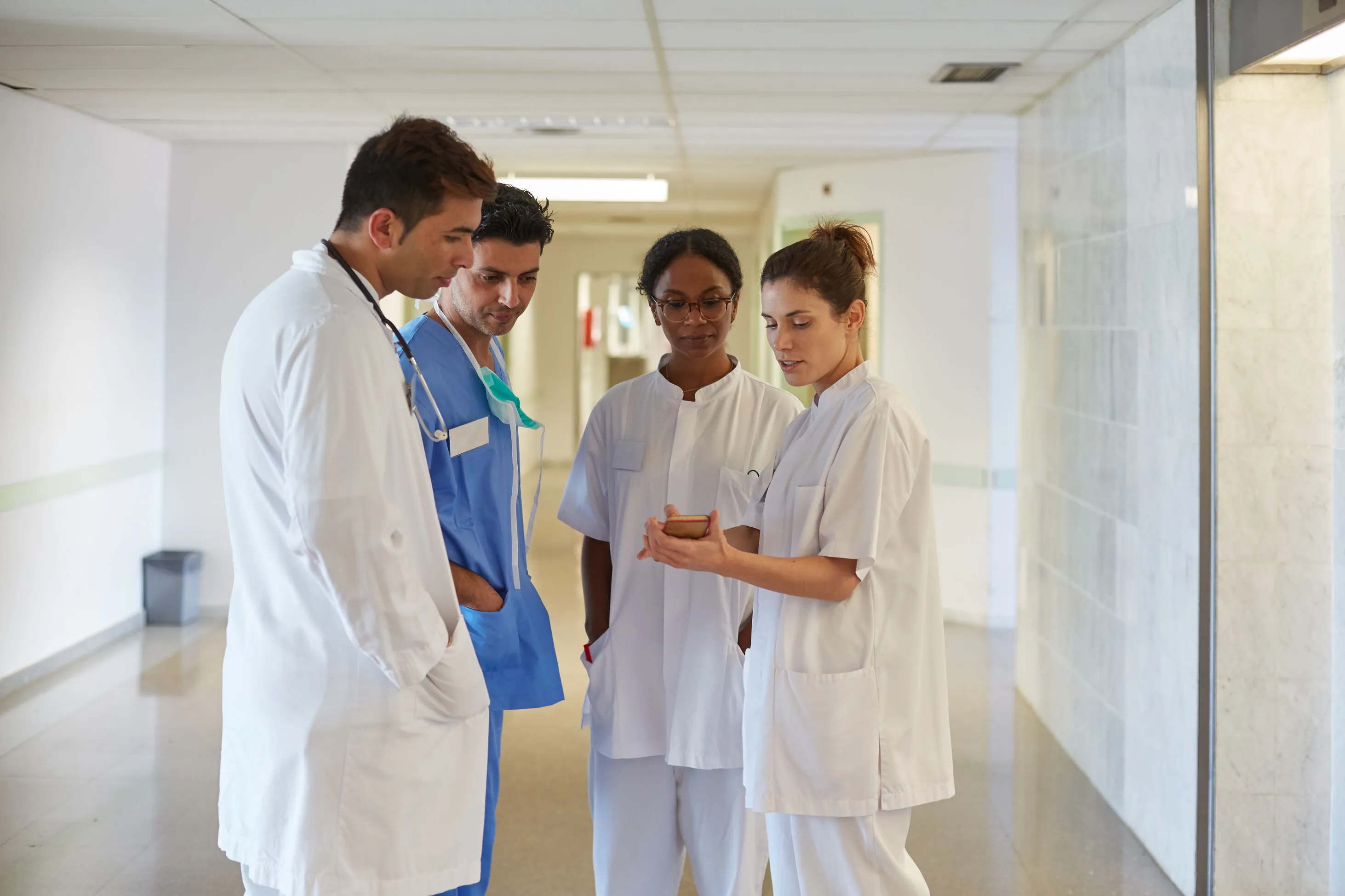 clinicians and nurses discussing work at hospital