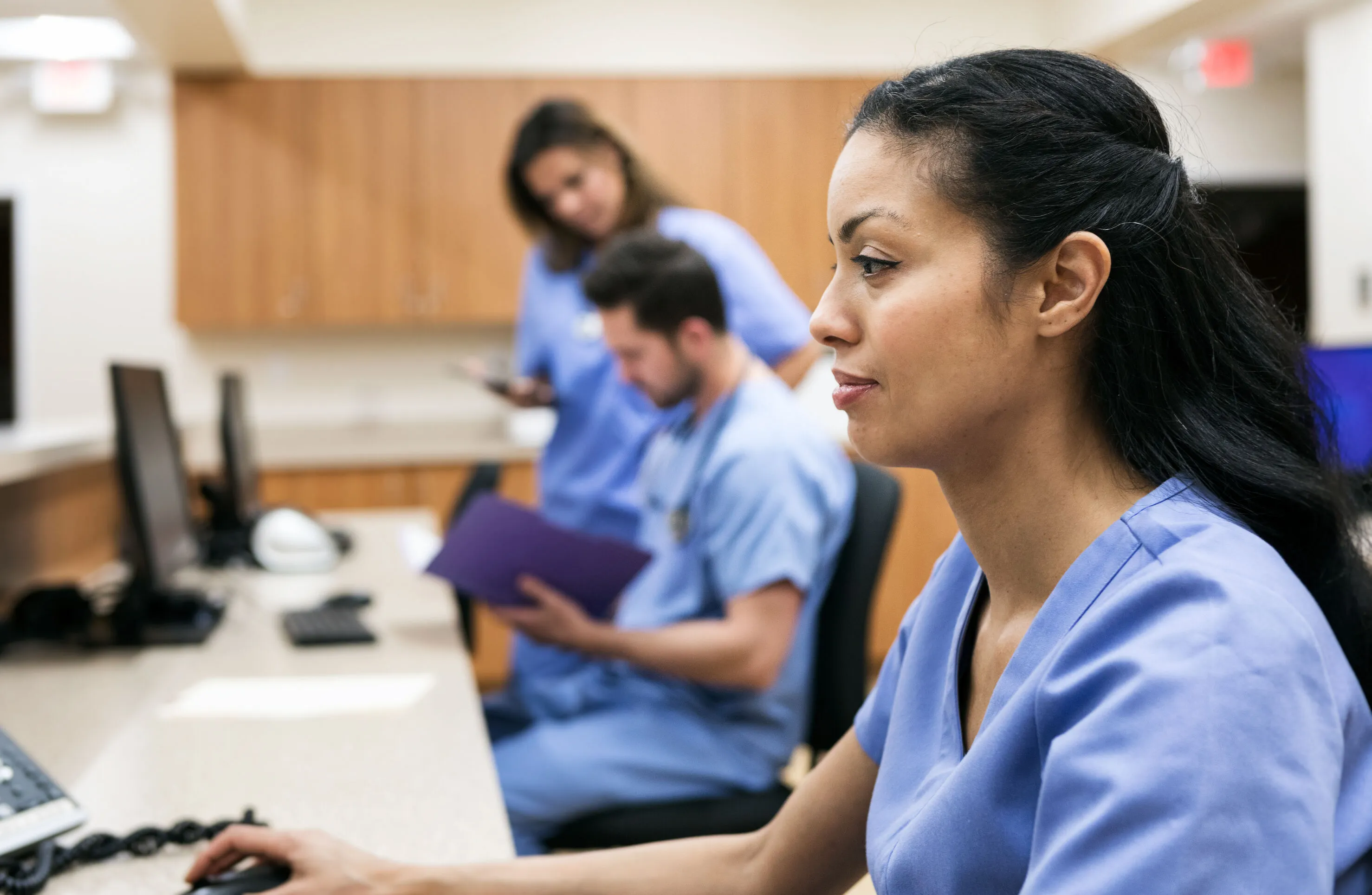 confident clinician at computer