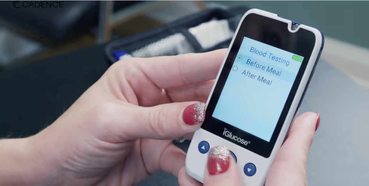 Image of a Cadence Care professional teaching how to use a blood glucometer
