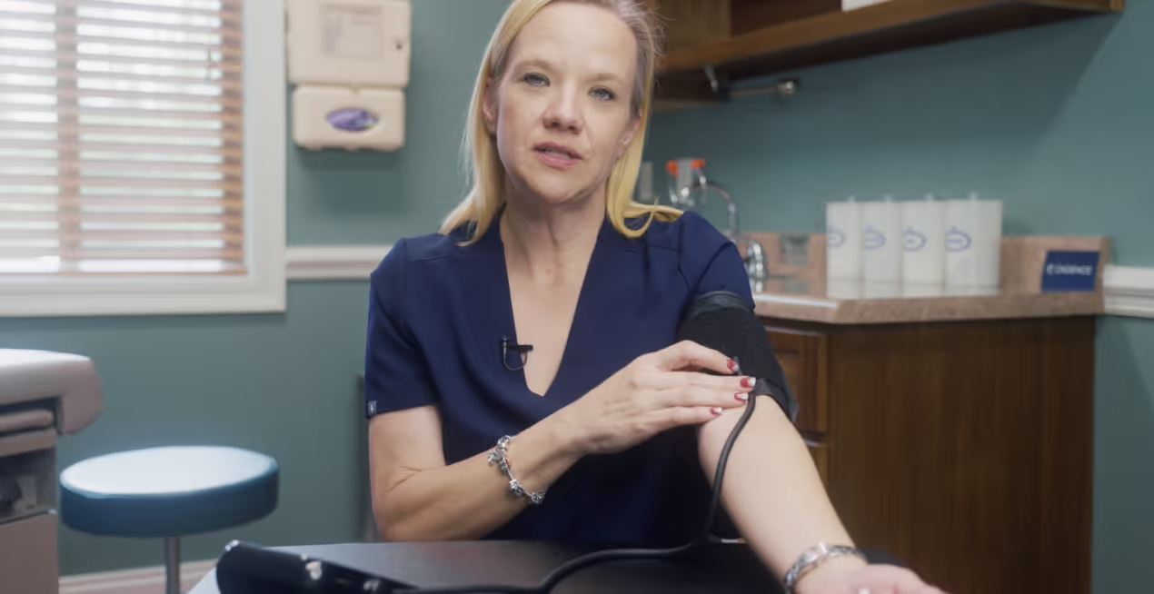 Image of a Cadence Care professional teaching how to use a blood pressure cuff
