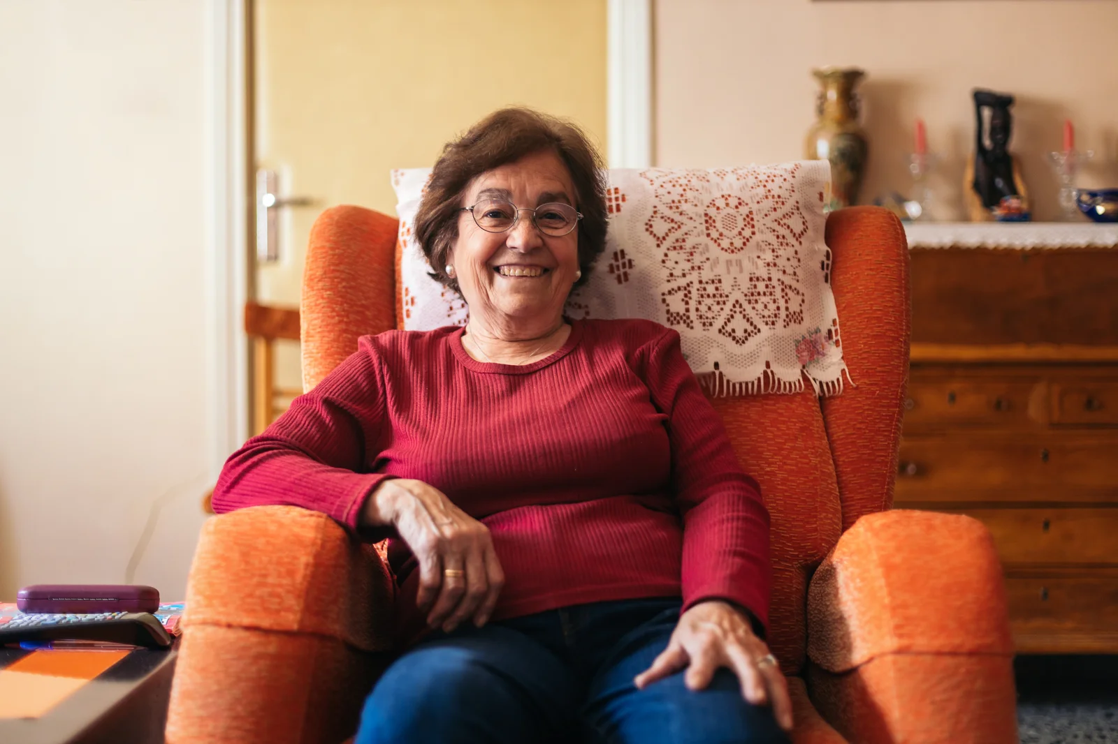 older woman smiles in armchair