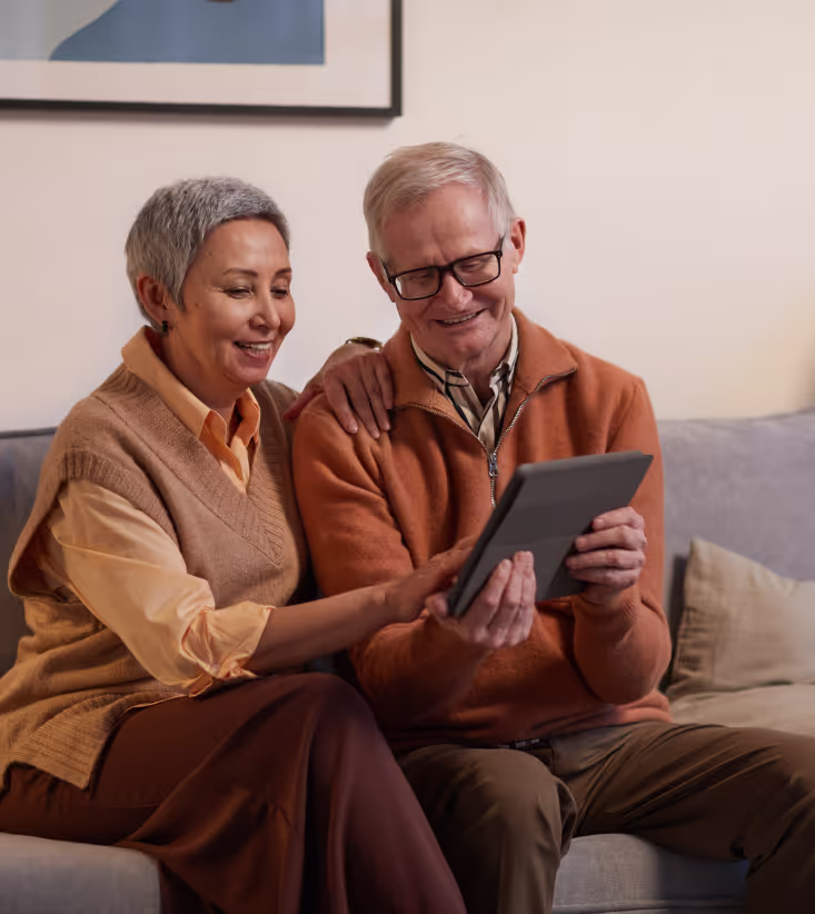 Cute elderly couple contacting their provider on a tablet
