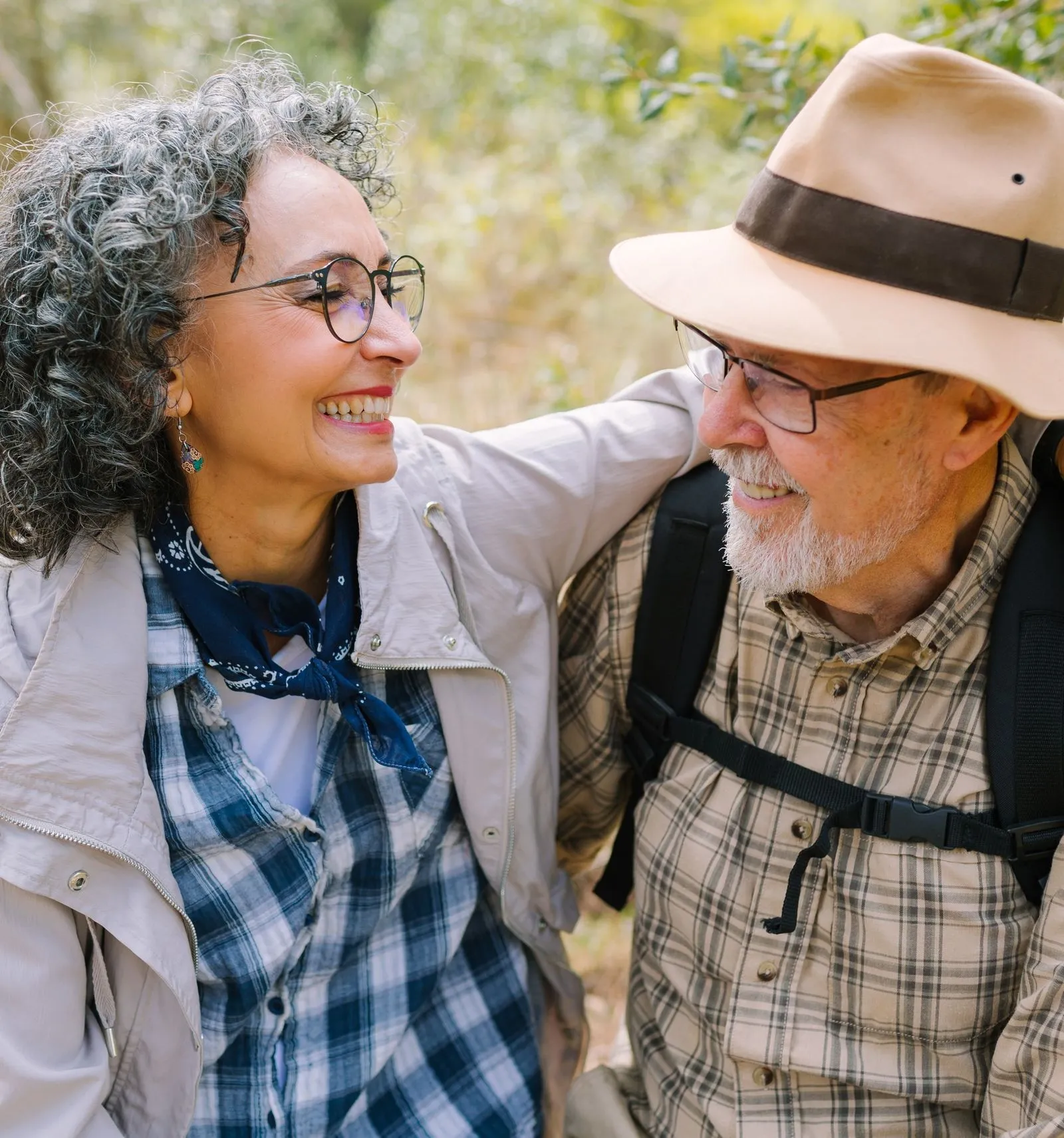 Older couple laughs together on hike